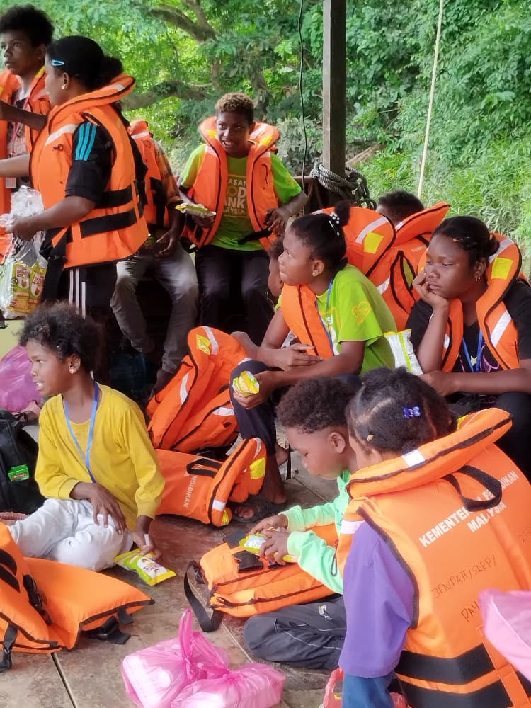 Orang Asli students travelling by boat